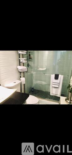 A bathroom with a toilet, sink, and shower.