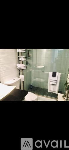 A bathroom with a toilet, sink, and shower.