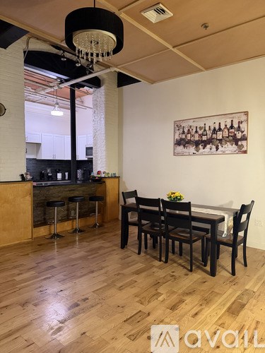 A dining room with a wooden table and chairs.