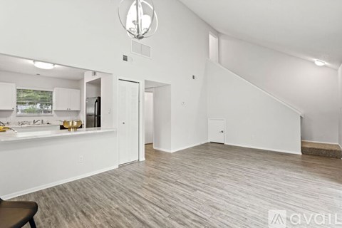 A spacious room with a staircase leading to the upper floor.