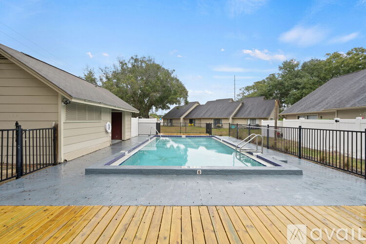 A small pool in a backyard surrounded by a fence.