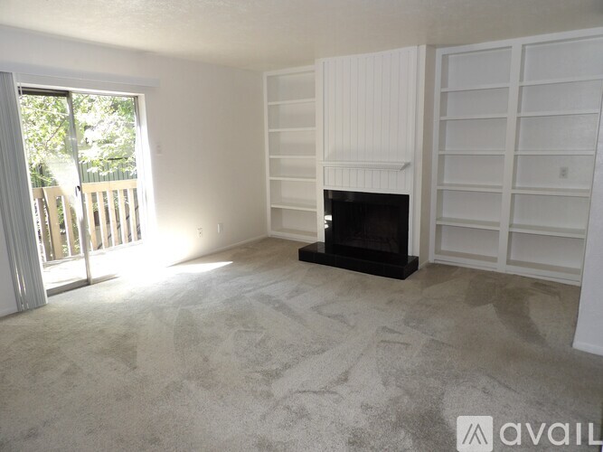 A living room with a fireplace and a carpet.