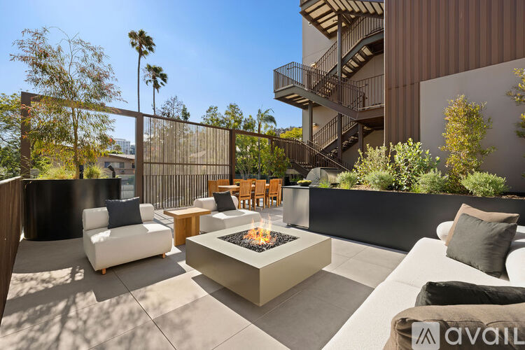 A patio with a fire pit and seating area.
