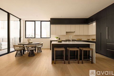 A modern kitchen with a dining table and chairs.