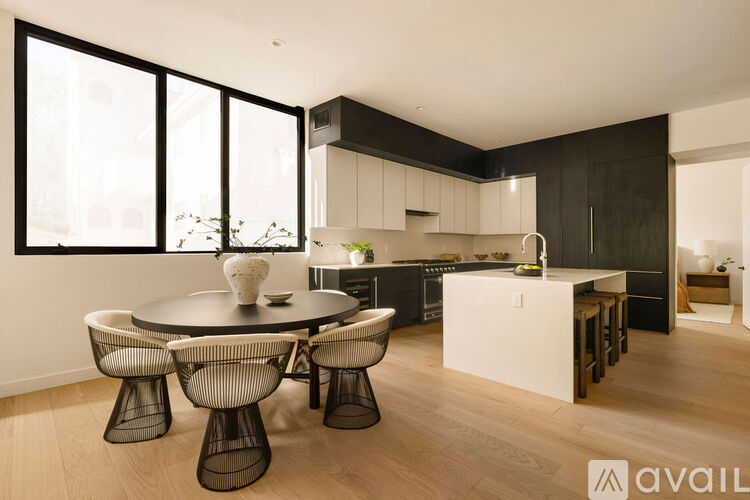 A modern kitchen with a dining table and chairs.