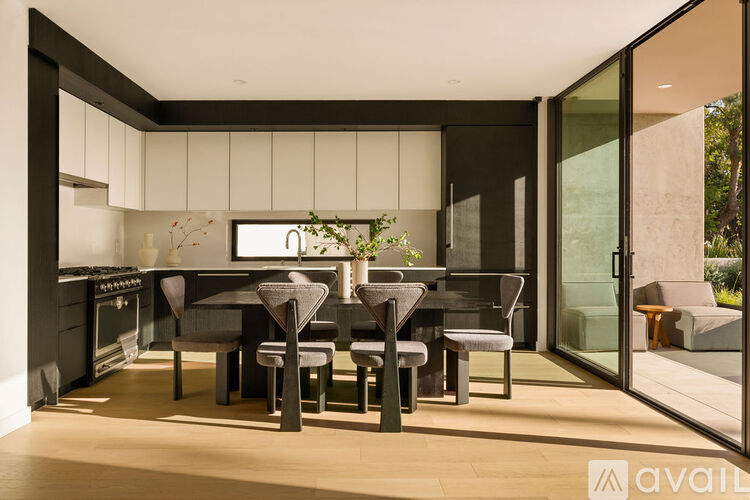 A modern kitchen with a dining table and chairs.