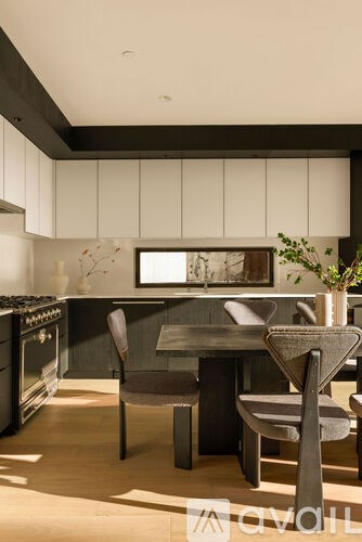 A modern kitchen with a dining table and chairs.