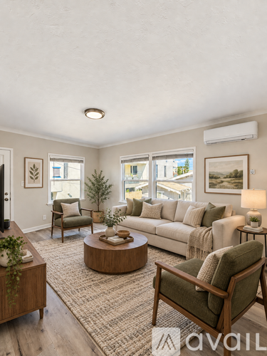 A living room with a couch, chairs, and a coffee table.
