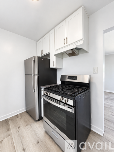 A kitchen with a stainless steel refrigerator and oven.