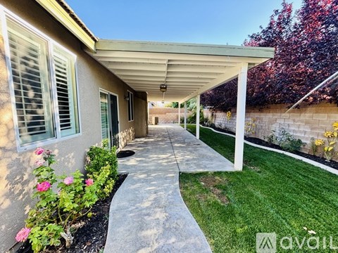 A house with a covered walkway and a garden.