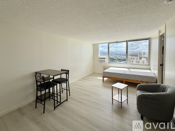 A living room with a table, two chairs, and a sofa.