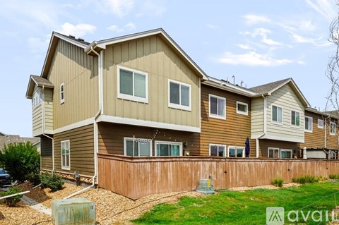 A large two story house with a brown and beige exterior.