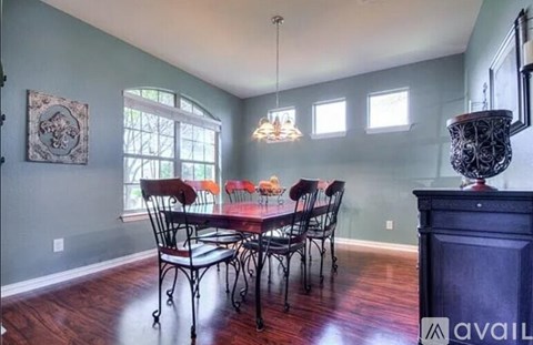 A dining room with a table set for six.