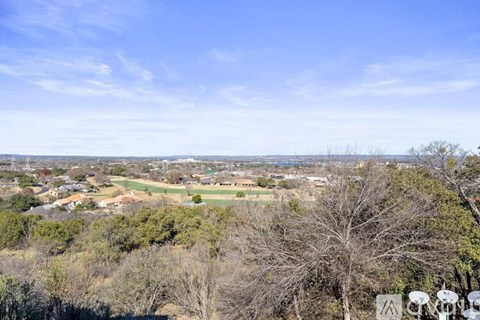 A view of a residential area with houses and trees.