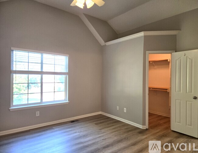 A room with a window and a door is available for rent.