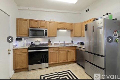 A kitchen with wooden cabinets and stainless steel appliances.