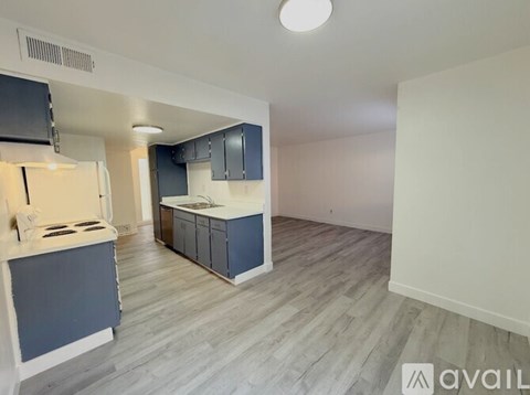 A kitchen with a stove top oven and a refrigerator.