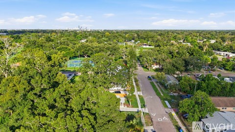 A bird's eye view of a residential area with a swimming pool.
