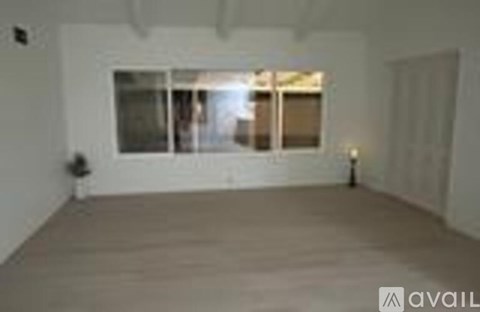 A room with a large window and a door.