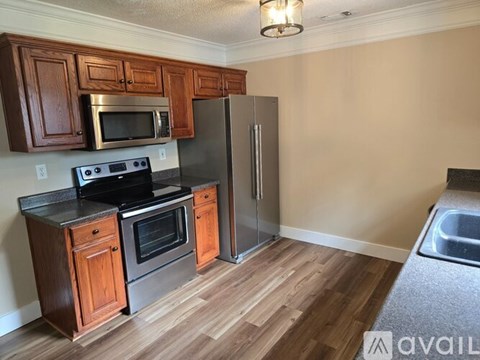 A kitchen with wooden cabinets and stainless steel appliances.