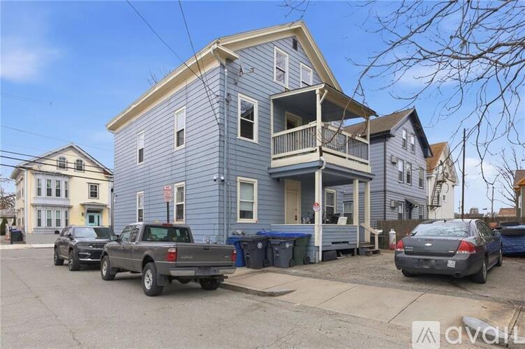 A two-story house with a garage apartment on the upper level is for sale.