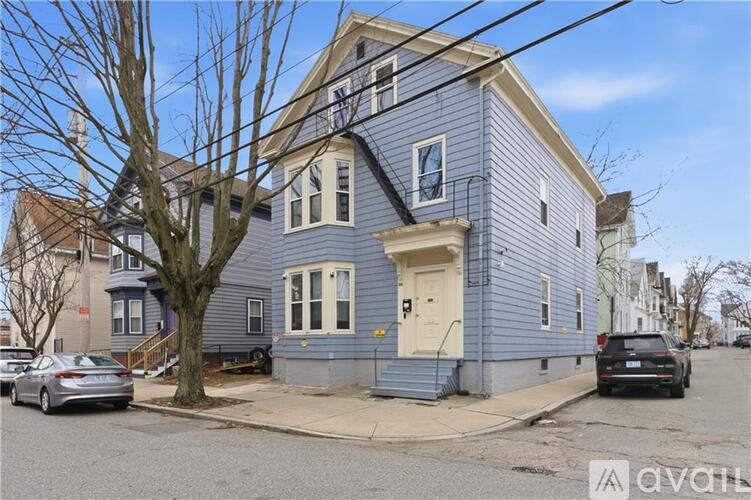 A blue house with a white door and windows is for sale.