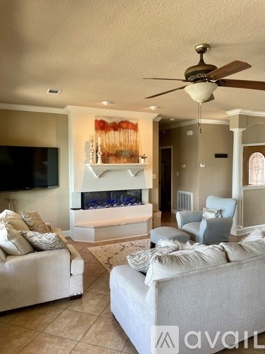 A living room with a fireplace and a television.