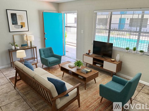 A living room with a blue chair and a wooden sofa.
