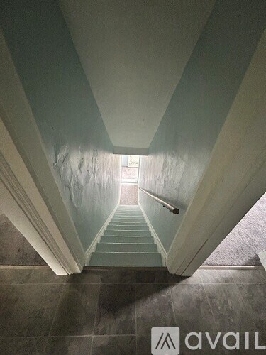 A staircase with a light at the end.