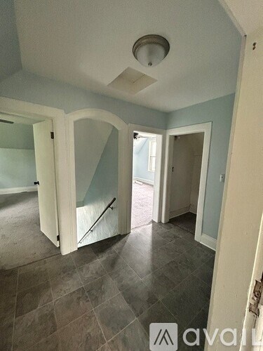 A room with a tiled floor and a ceiling fan.