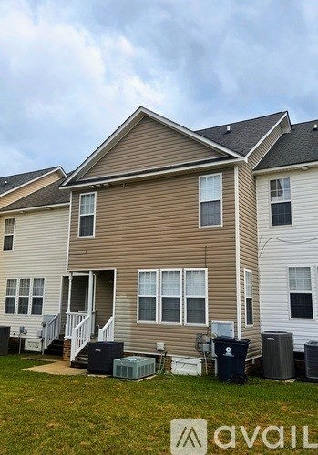 A two-story house with a brown and beige exterior is shown.
