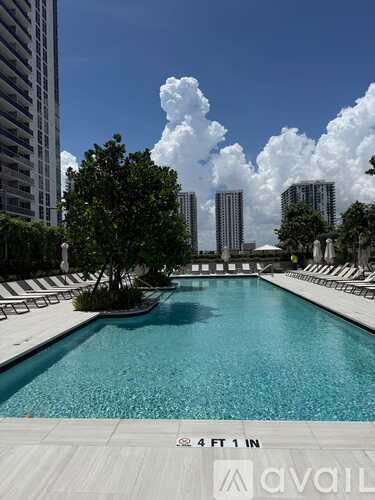 A pool with a depth of 4.4 feet 1 inch is shown in the foreground with a city skyline in the background.