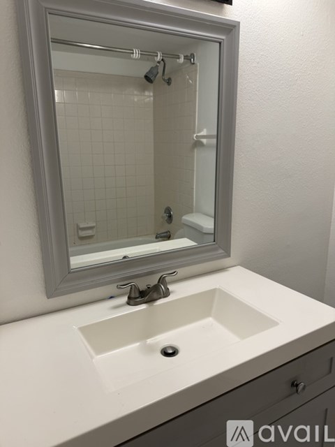 A bathroom sink with a mirror above it.
