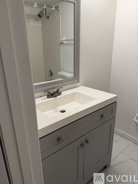 A bathroom with a sink and a mirror.