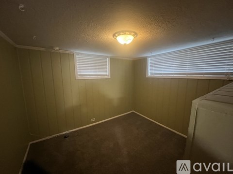 A room with a window and a light on the ceiling.