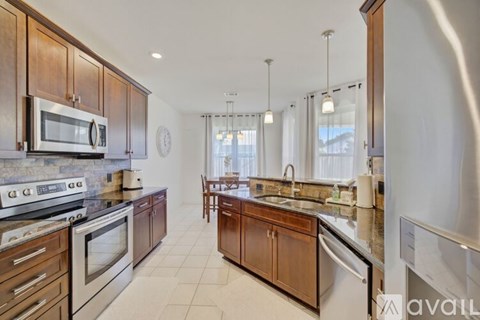 A kitchen with wooden cabinets and stainless steel appliances.