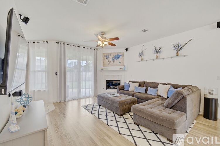 A living room with a grey couch and a white coffee table.