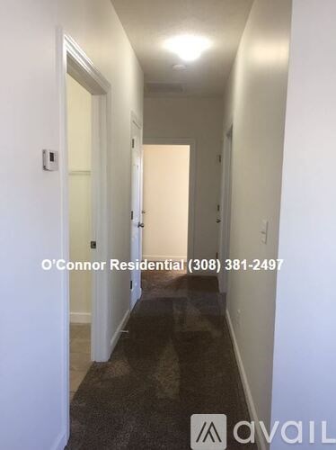 A hallway with a door at the end and a sign that says O'Connor Residential.