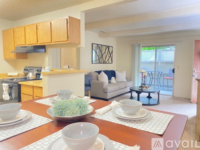 A kitchen with a dining table set for two.