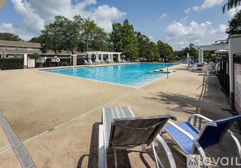 A swimming pool with chairs around it.