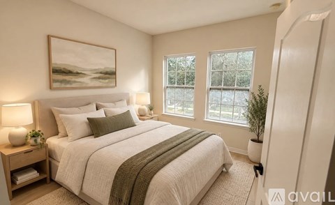 A bedroom with a large bed and a painting on the wall.