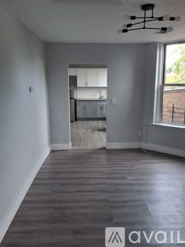 A room with wooden flooring and a ceiling fan.