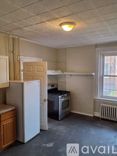 A kitchen with a white refrigerator and a dishwasher.