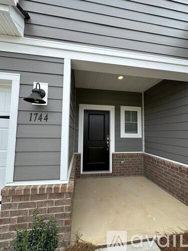 A grey house with the number 1744 on the wall.