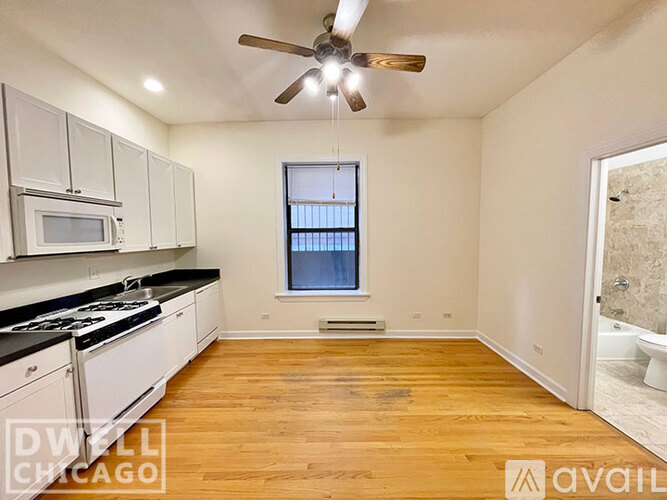 A kitchen with white cabinets and a black stove top oven.