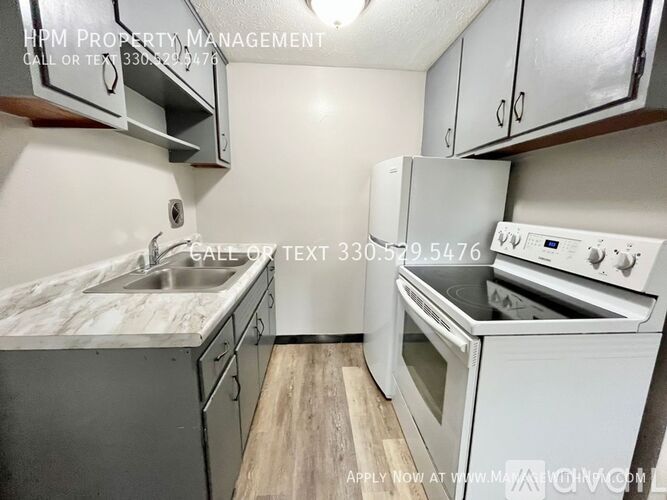 A kitchen with a sink, stove, and cabinets is for rent.