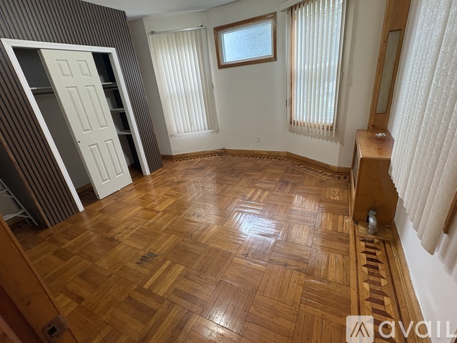 A room with wooden flooring and a white door.
