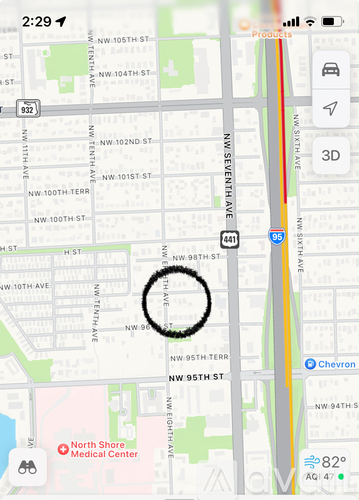 A map with a circle around a section of it and a red marker on the bottom left.