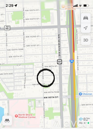 A map with a circle around a section of it and a red marker on the bottom left.