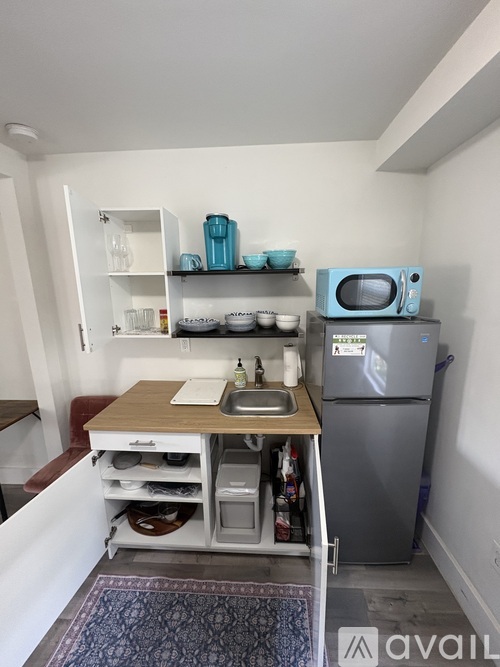 A kitchen with a wooden table and a blue microwave.